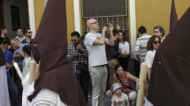 Turistas fotografían una de las cofradías del Miércoles Santo